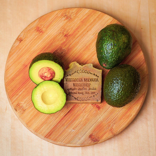 avocado and avocado soap on wooden table 